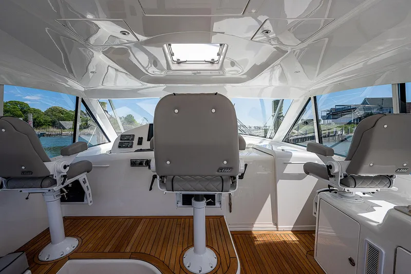 Wanted Yacht Photos Pics Interior of 2012 Cabo 44 HTX yacht with modern helm and seating.