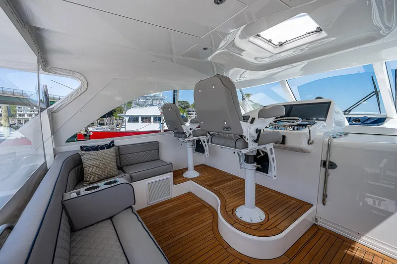 Wanted Yacht Photos Pics Luxurious interior of 2012 Cabo 44 HTX yacht with modern seating and helm.