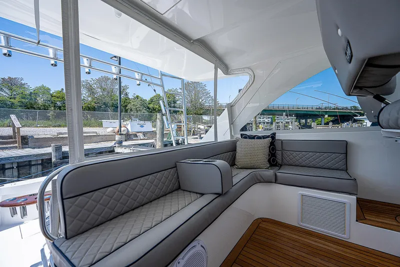 Wanted Yacht Photos Pics Luxurious interior of 2012 Cabo 44 HTX yacht with elegant seating and wood flooring.