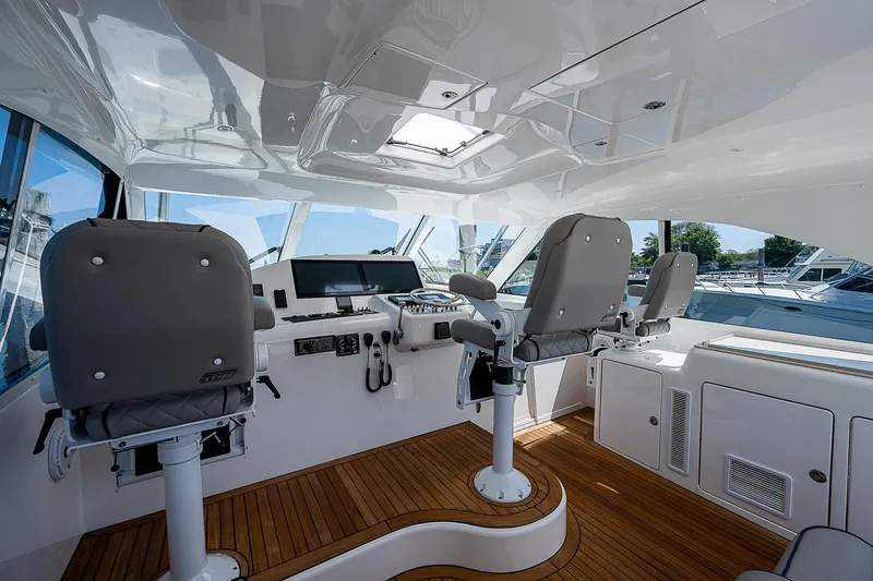 Wanted Yacht Photos Pics Interior of 2012 Cabo 44 HTX yacht with helm station and seating.