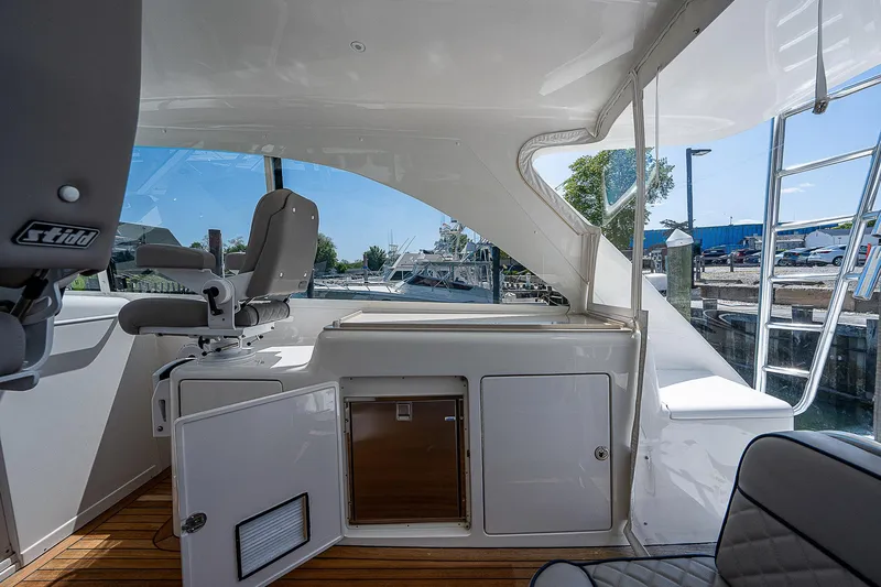 Wanted Yacht Photos Pics Interior view of 2012 Cabo 44 HTX yacht with seating and storage.