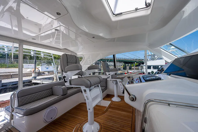 Wanted Yacht Photos Pics Luxurious 2012 Cabo 44 HTX yacht interior with plush seating and modern controls.