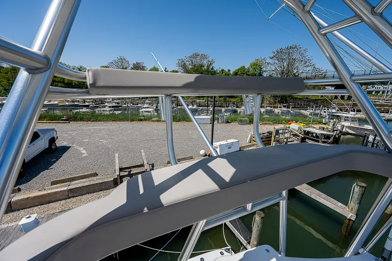 Wanted Yacht Photos Pics Cabo 44 HTX 2012 boat with sleek metal framework and marina view.