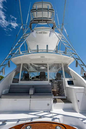 Wanted Yacht Photos Pics 2012 Cabo 44 HTX yacht with tower, sleek design, and spacious deck under clear blue sky.