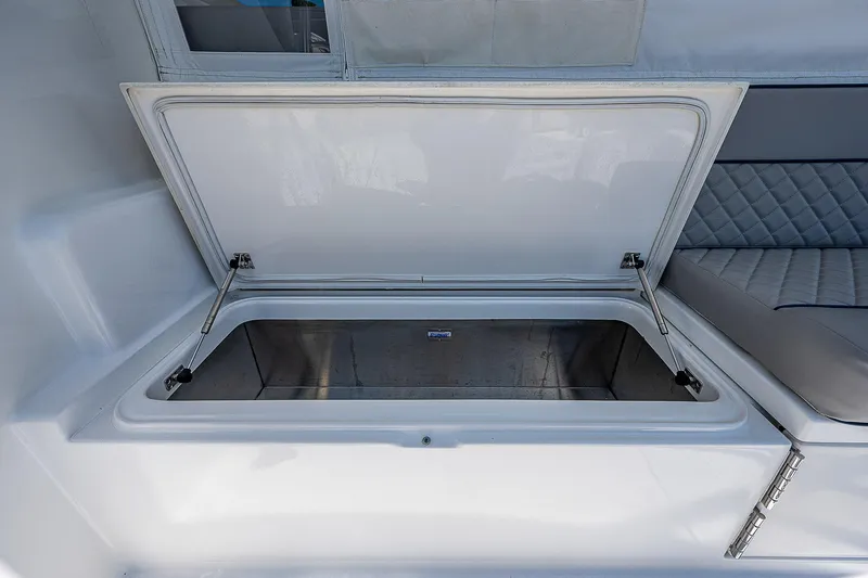 Wanted Yacht Photos Pics Open storage compartment on a 2012 Cabo 44 HTX boat interior.