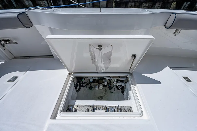 Wanted Yacht Photos Pics Open hatch on 2012 Cabo 44 HTX boat deck, revealing storage compartment.