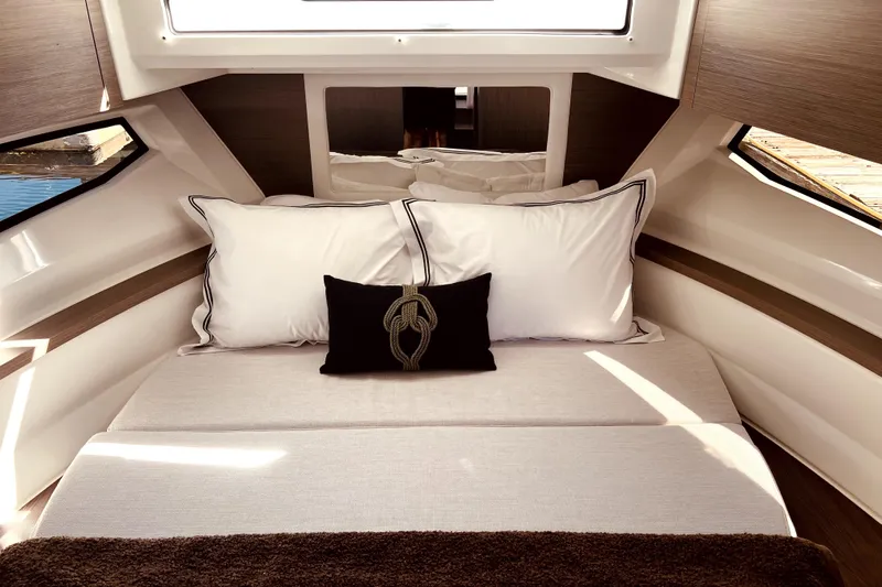 "halo" Yacht Photos Pics Luxurious cabin interior of 2024 Jeanneau 8.95 boat with elegant bedding and modern design.