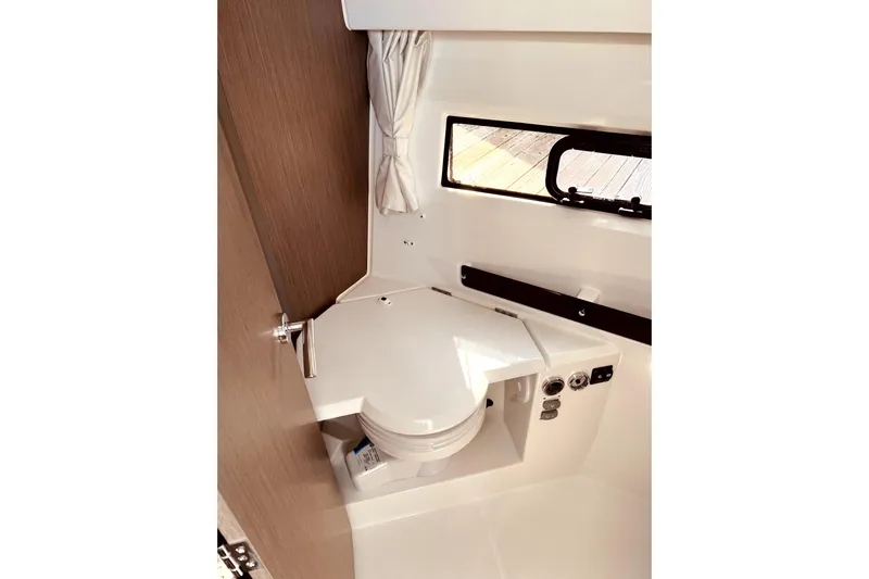 "halo" Yacht Photos Pics 2024 Jeanneau 8.95 boat interior bathroom with compact toilet and window.