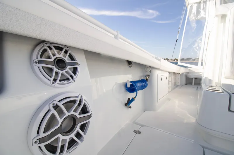  Yacht Photos Pics 2025 Yellowfin 32 Offshore boat interior with speakers and coiled hose.