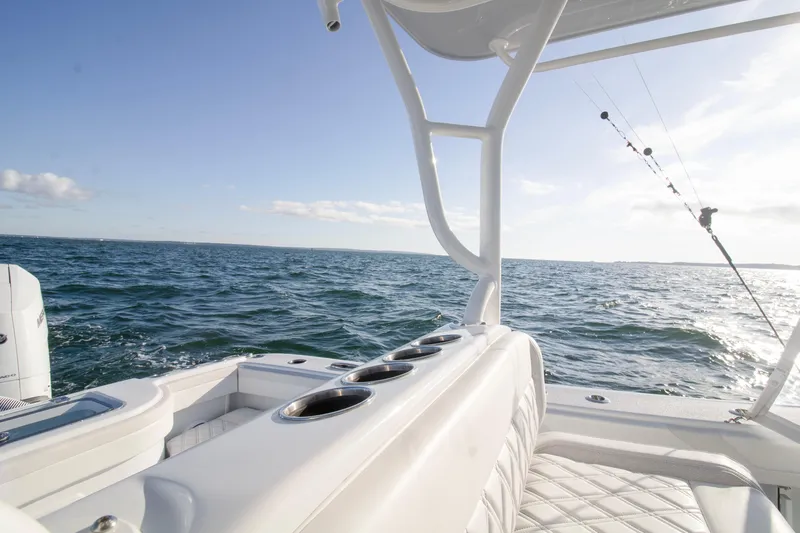  Yacht Photos Pics 2025 Yellowfin 32 Offshore boat on open sea with fishing rod.