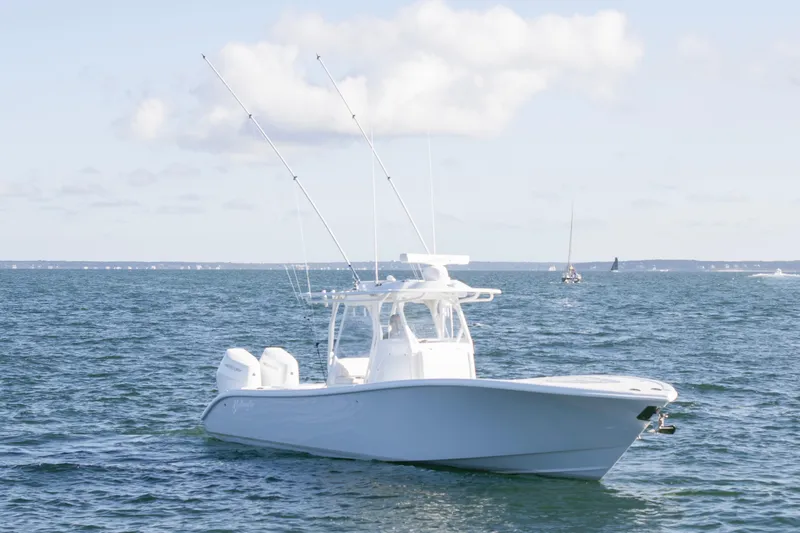  Yacht Photos Pics 2025 Yellowfin 32 Offshore boat on open water under a clear sky.