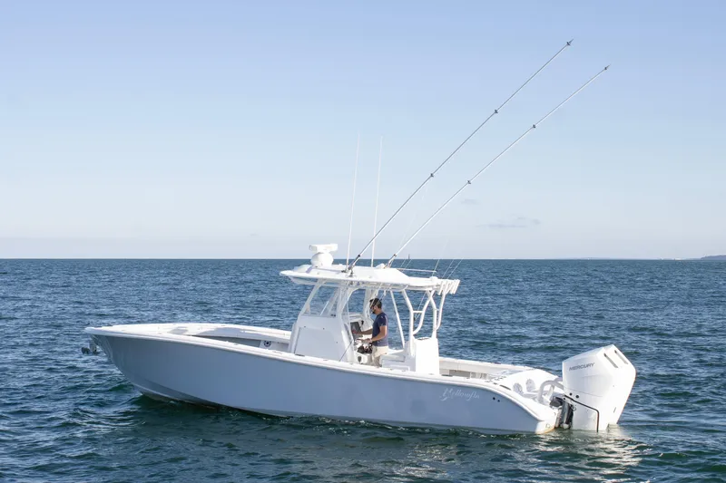  Yacht Photos Pics 2025 Yellowfin 32 Offshore boat on open water, featuring dual outboard engines.
