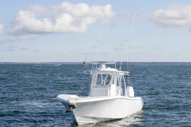  Yacht Photos Pics 2025 Yellowfin 32 Offshore boat cruising on open water under a clear sky.