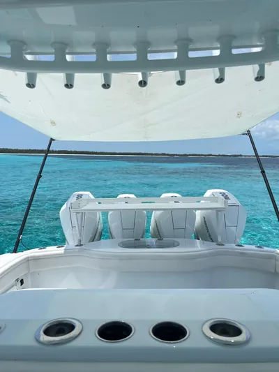  Yacht Photos Pics 2022 Yellowfin 39 Offshore boat on clear turquoise water, showcasing powerful engines.