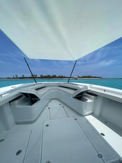  Yacht Photos Pics 2022 Yellowfin 39 Offshore boat deck with canopy, clear blue sky, and turquoise water.