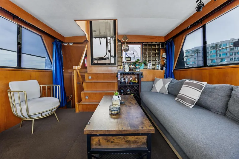 The Aquaholic Yacht Photos Pics Interior of 1988 Marine Trader Trawler with cozy seating, wooden accents, and nautical decor.