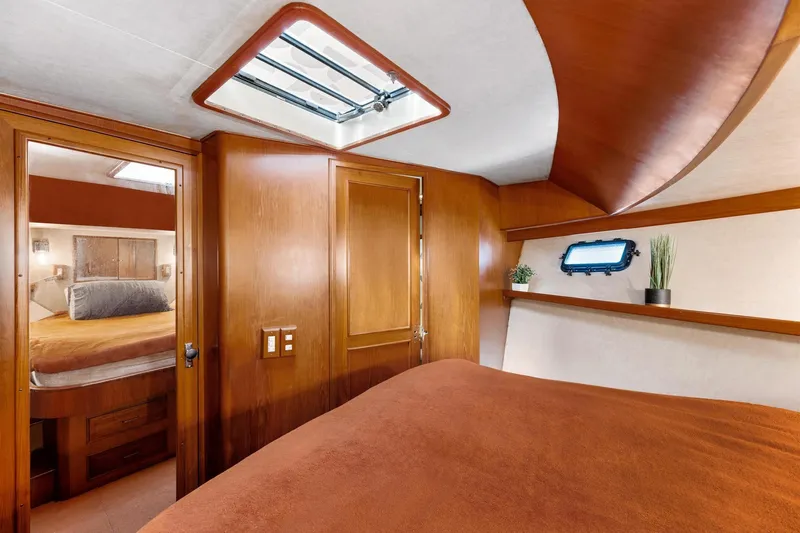The Aquaholic Yacht Photos Pics 1988 Marine Trader Trawler cabin interior with wood paneling and skylight.