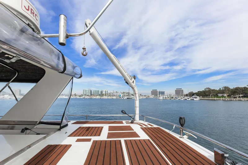 The Aquaholic Yacht Photos Pics 1988 Marine Trader Trawler deck with scenic marina view under blue sky.