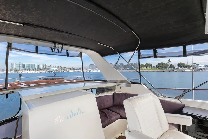 The Aquaholic Yacht Photos Pics 1988 Marine Trader Trawler interior with seating, overlooking marina and waterfront views.