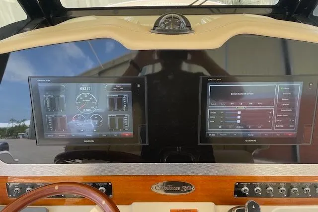 Yacht Photos Pics 2020 Chris-Craft Catalina 30 dashboard with dual Garmin displays and wooden accents.