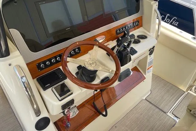 Yacht Photos Pics 2020 Chris-Craft Catalina 30 helm with wooden steering wheel and modern controls.