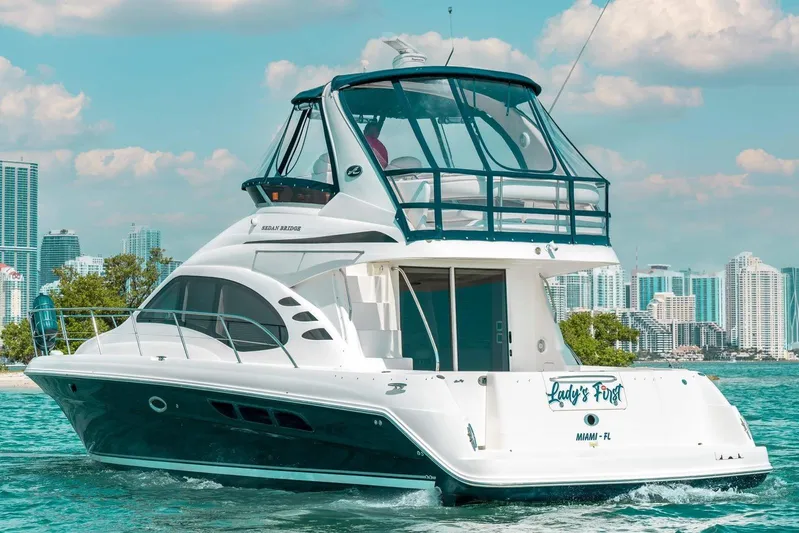  Yacht Photos Pics 2005 Sea Ray 420 Sedan Bridge yacht cruising near Miami skyline.