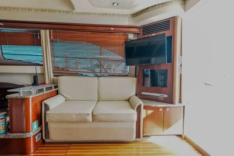  Yacht Photos Pics Interior of 2005 Sea Ray 420 Sedan Bridge with sofa and mounted TV.