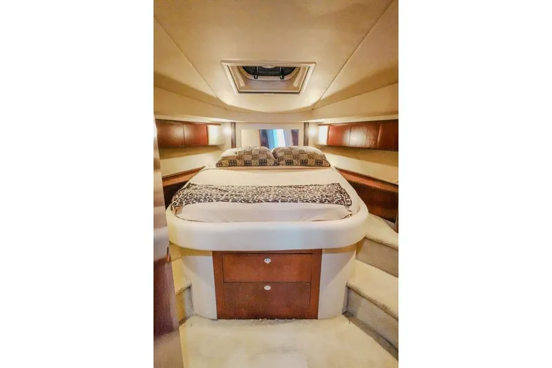  Yacht Photos Pics 2005 Sea Ray 420 Sedan Bridge cabin interior with bed and wooden cabinetry.