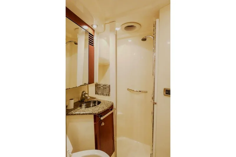  Yacht Photos Pics Bathroom interior of 2005 Sea Ray 420 Sedan Bridge yacht, featuring sink and shower.