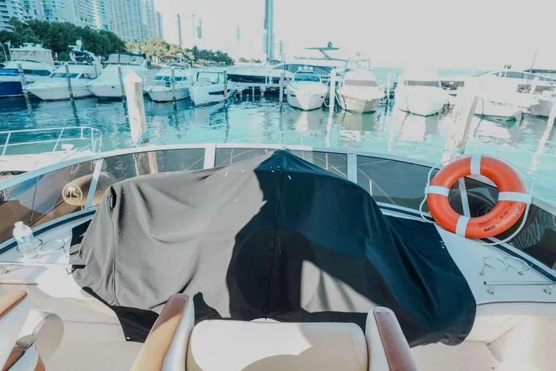  Yacht Photos Pics 2005 Sea Ray 420 Sedan Bridge at marina with life preserver and covered equipment.