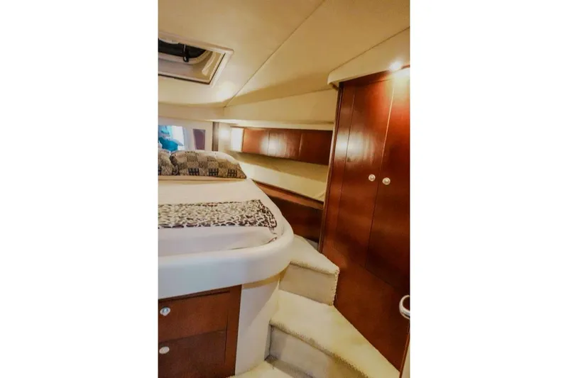  Yacht Photos Pics 2005 Sea Ray 420 Sedan Bridge cabin interior with bed and wooden cabinetry.