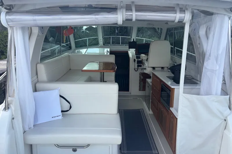 Fifth Child Yacht Photos Pics Interior view of 2019 Back Cove 34O boat with seating and kitchenette.