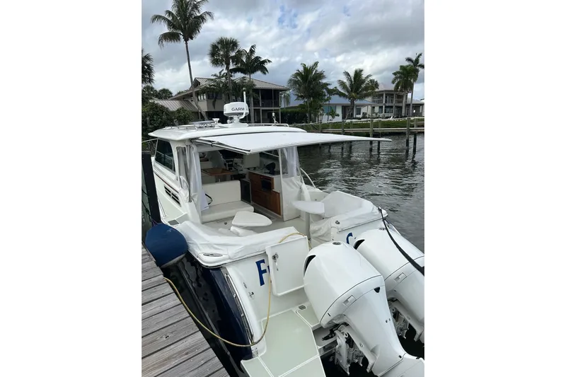 Fifth Child Yacht Photos Pics 2019 Back Cove 34O boat docked, featuring dual outboard engines and a sleek design.