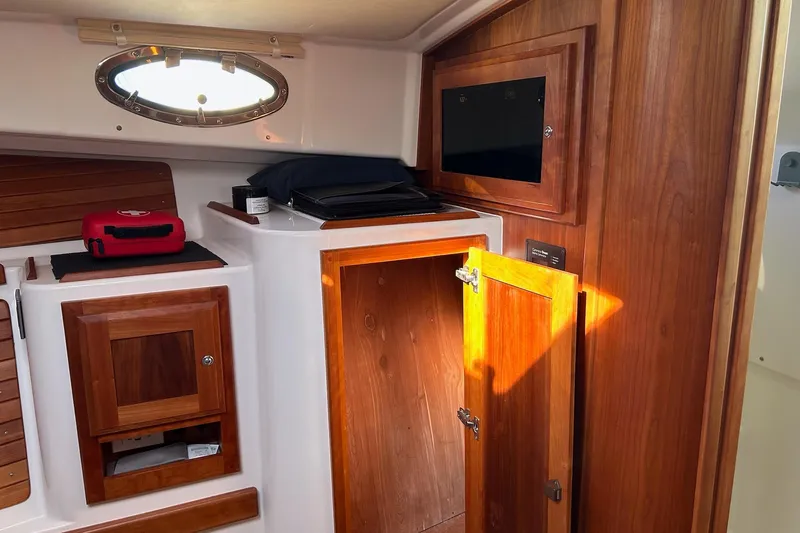 Fifth Child Yacht Photos Pics Interior of 2019 Back Cove 34O boat with wooden cabinetry and storage compartments.