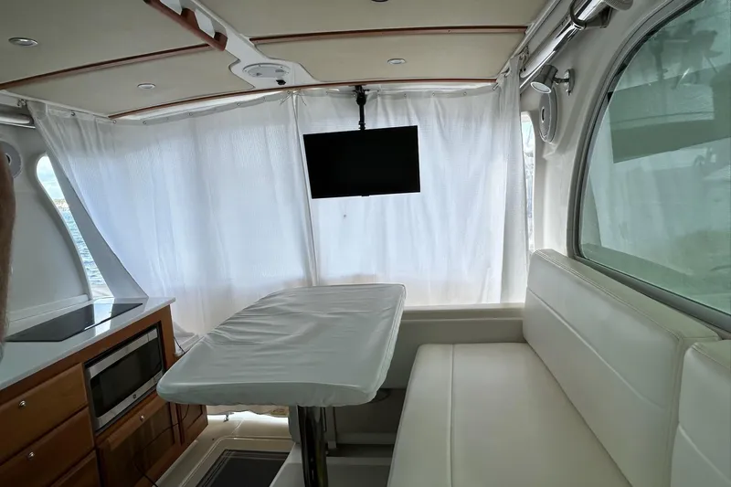 Fifth Child Yacht Photos Pics Interior of 2019 Back Cove 34O yacht with seating, table, and TV.