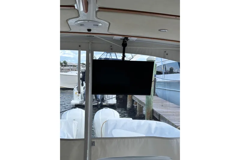 Fifth Child Yacht Photos Pics 2019 Back Cove 34O boat interior with mounted TV and marina view.