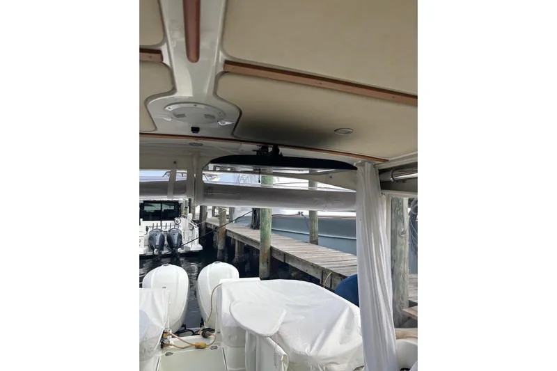 Fifth Child Yacht Photos Pics 2019 Back Cove 34O boat interior with dock view and covered outboard engines.