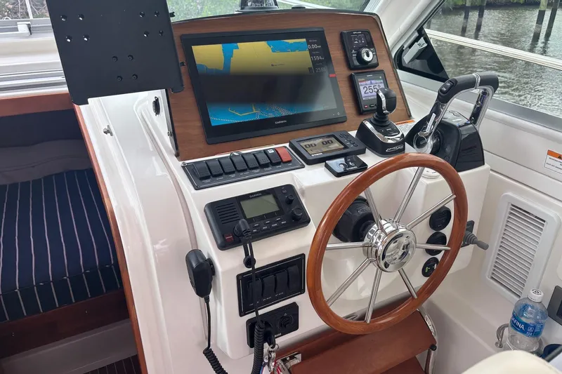 Fifth Child Yacht Photos Pics Helm of 2019 Back Cove 34O boat with navigation equipment and steering wheel.
