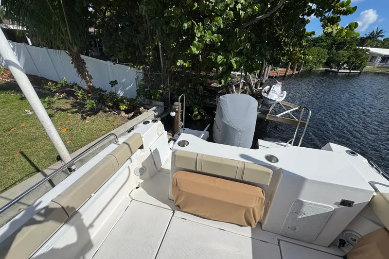  Yacht Photos Pics 2021 Ranger Tugs R-25 boat deck with seating, near a waterfront dock.