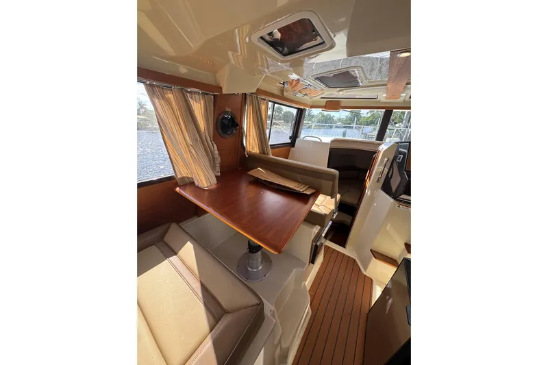  Yacht Photos Pics Interior of 2021 Ranger Tugs R-25, featuring a cozy dining area with wood accents.