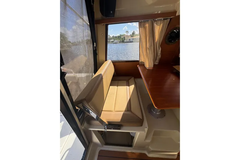  Yacht Photos Pics Interior of 2021 Ranger Tugs R-25 with seating and table, overlooking water view.