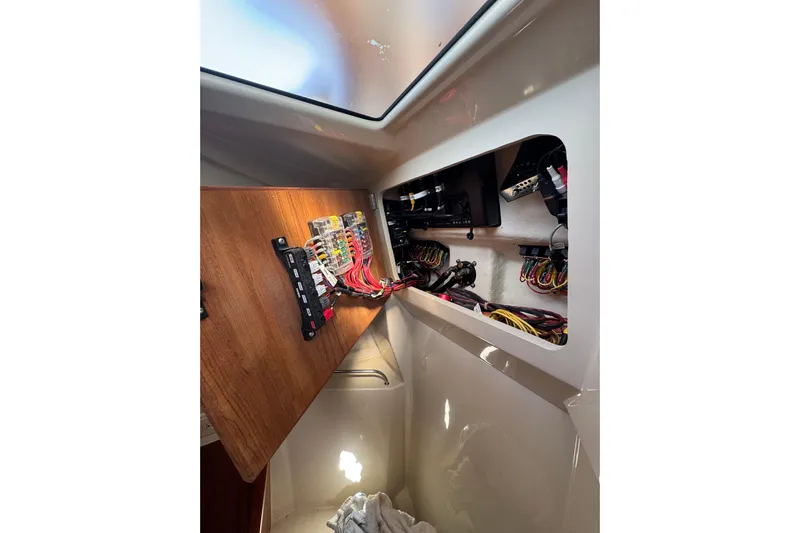  Yacht Photos Pics Electrical panel inside 2021 Ranger Tugs R-25 boat, showcasing wiring and components.