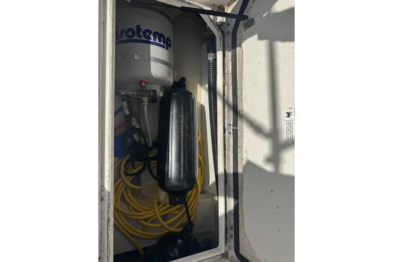  Yacht Photos Pics Storage compartment of 2021 Ranger Tugs R-25 with Isotemp equipment and coiled yellow hose.