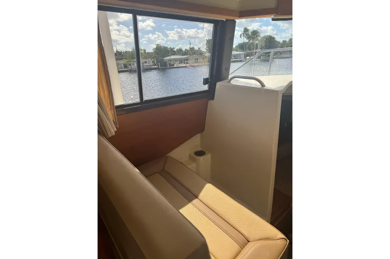  Yacht Photos Pics Interior view of 2021 Ranger Tugs R-25 boat with seating and window overlooking water.