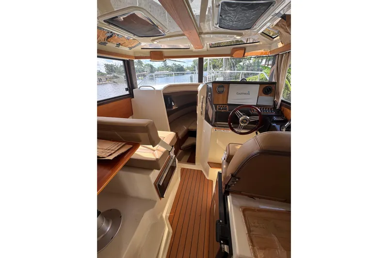  Yacht Photos Pics Interior of 2021 Ranger Tugs R-25 boat with Garmin navigation system and wood accents.