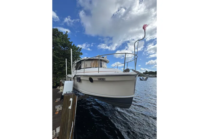  Yacht Photos Pics 2021 Ranger Tugs R-25 boat docked on a sunny day with blue sky.
