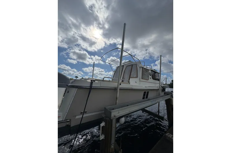  Yacht Photos Pics 2021 Ranger Tugs R-25 boat docked under cloudy sky.