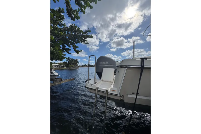  Yacht Photos Pics 2021 Ranger Tugs R-25 boat with Yamaha engine on a sunny day by the water.