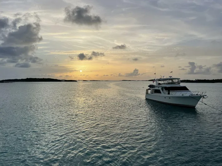 Mountain Mermaid Yacht Photos Pics 2004 Offshore Yachts 54 Pilothouse at sunset on tranquil waters.