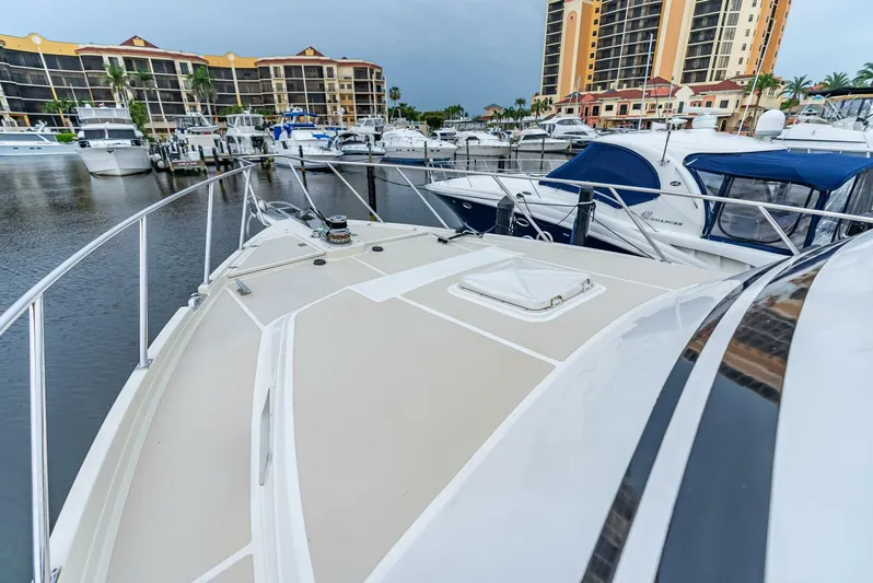 Mountain Mermaid Yacht Photos Pics 2004 Offshore Yachts 54 Pilothouse docked in marina with surrounding boats and buildings.